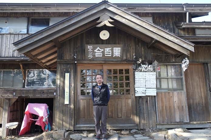 小屋の前に立つ米川さん